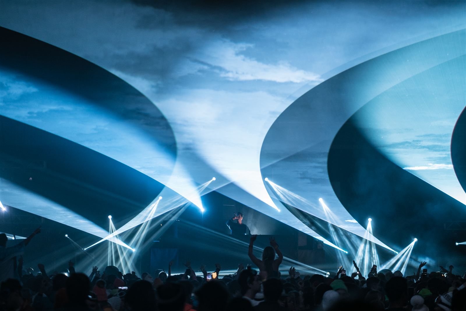EDM festival stages — beam looks against a dusk sky